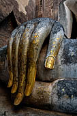 Thailand - Old Sukhothai - Wat Si Chum the right hand with long fingers of the impressive 15 meter high seated Buddha statue is a representative example of Sukhothai sculpture.